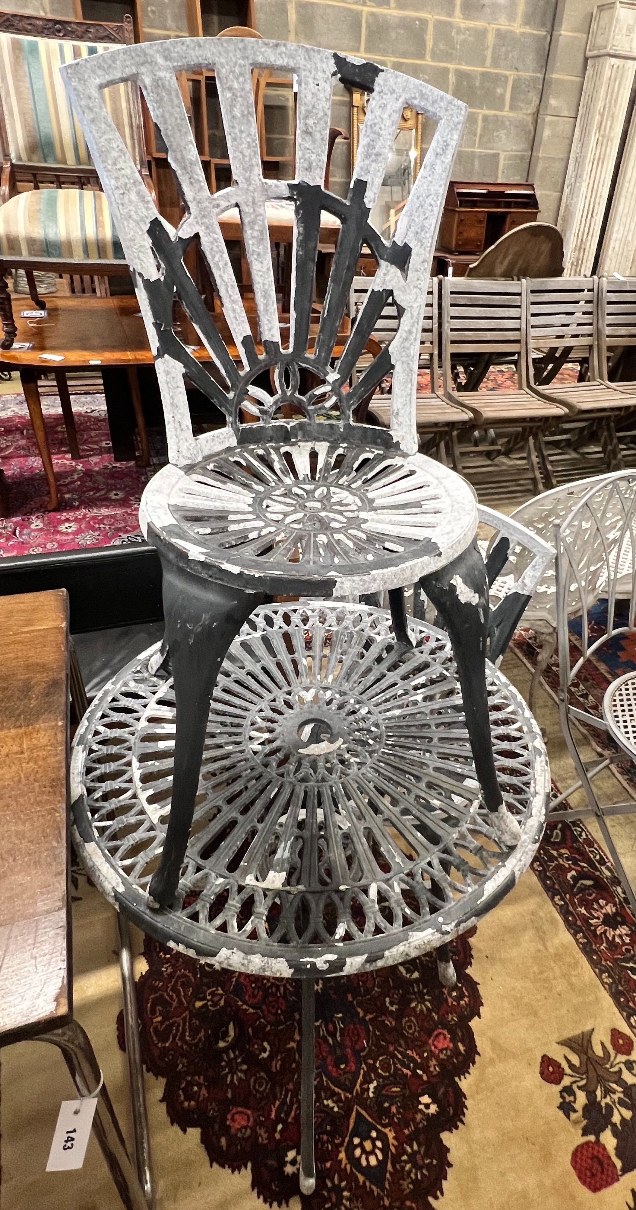 A circular aluminium garden table and two chairs, table diameter 69cm height 67cm